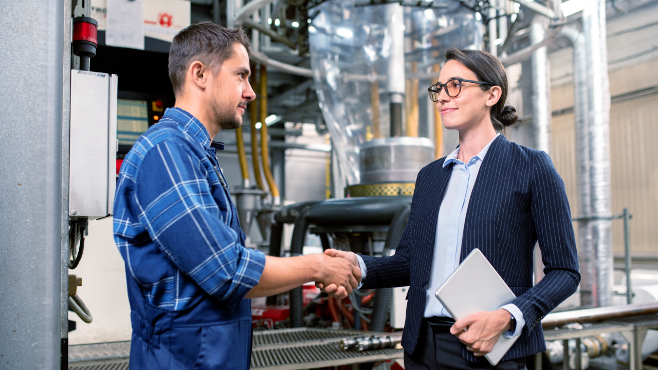 Feature image Shoplogix blog post about choosing the right manufacturing partner with two workers shaking hands